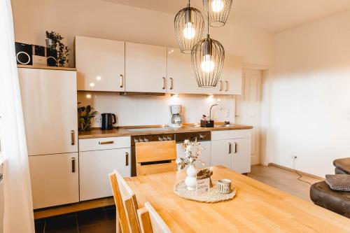 a kitchen and dining room with a wooden table at Huxfeld-Hof - Landlust in Grasberg