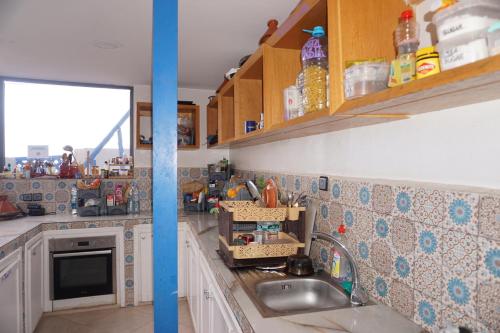 a kitchen with a sink and a counter top at Hostel The Endless House Anchor point in Taghazout