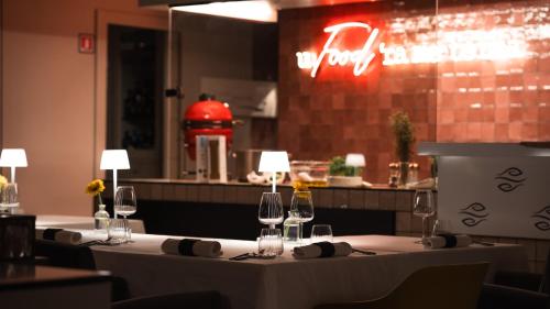 a restaurant with a table with wine glasses on it at Altafiumara Resort & Spa in Villa San Giovanni