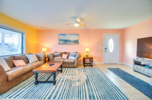 a living room with a couch and a tv at Sea La Vie by Carolina Beach Realty in Carolina Beach
