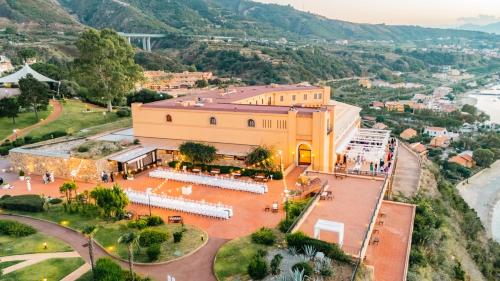 an overhead view of a large yellow building with a courtyard at Altafiumara Resort & Spa in Villa San Giovanni