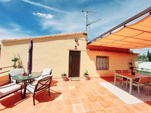a patio with a table and chairs and an umbrella at B&B Casa Josa in Ontinyent