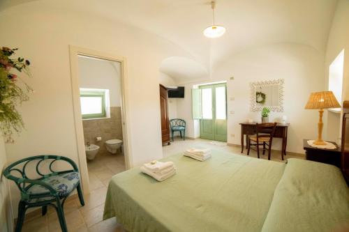 a bedroom with a bed and a desk in a room at Coppola di Seta in Locorotondo