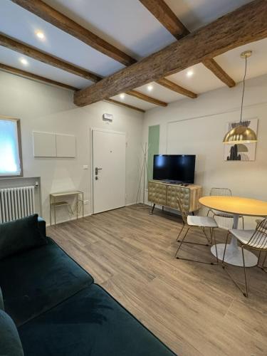 a living room with a couch and a table at HouSmart Emilia 15 in San Lazzaro di Savena
