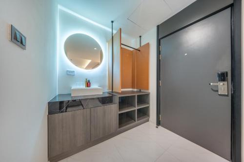 a bathroom with a sink and a mirror at U TOR Yaowarat in Bangkok