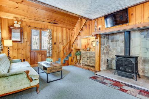 a living room with a fireplace and a couch at 2 Mi to Ossipee Lake Forest-View Sanctuary! in Freedom