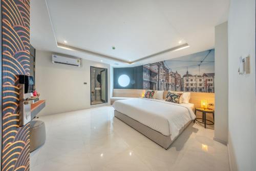 a bedroom with a large white bed in a room at U TOR Yaowarat in Bangkok
