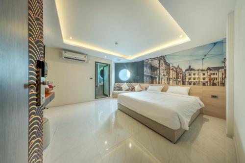 a bedroom with a white bed and a large window at U TOR Yaowarat in Bangkok
