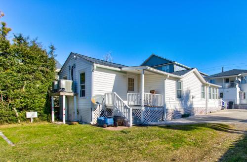 a white house with a fence in the yard at Seaside Cottage B by Carolina Beach Realty in Carolina Beach