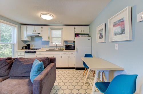 a living room with a couch and a table and a kitchen at Seaside Cottage B by Carolina Beach Realty in Carolina Beach