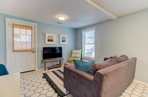 a living room with a couch and a television at Seaside Cottage B by Carolina Beach Realty in Carolina Beach