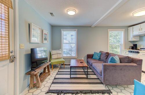 a living room with a couch and a tv at Seaside Cottage B by Carolina Beach Realty in Carolina Beach