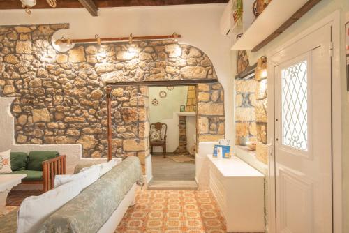 a room with a stone wall and a doorway at Philoxenia traditional house in Pastida