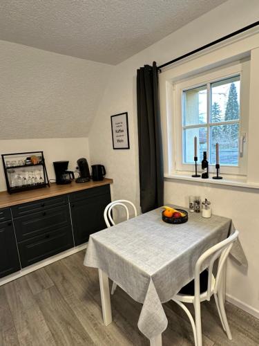 a kitchen with a table with a bowl of fruit on it at Fränkisches Nest am Schwanberg für 2-4 Personen - in der Nähe aller Weingüter, KNAUF GIPS KG und ConneKT in Iphofen