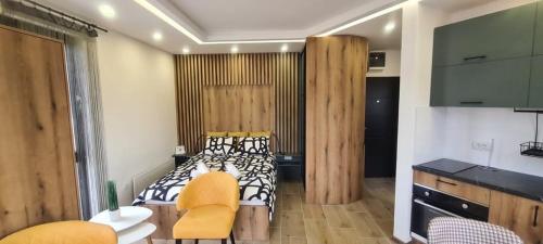 a bedroom with a bed and a table and chairs at Studio Andrea in Divčibare