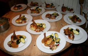 a group of plates of food on a wooden table at Naturist Hotel Peyraille in Libaros