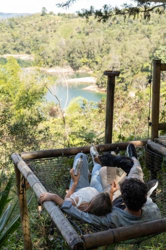 a group of three people laying on a swing at Levit Glamping - Hotel Guatapé Peñol in Guatapé