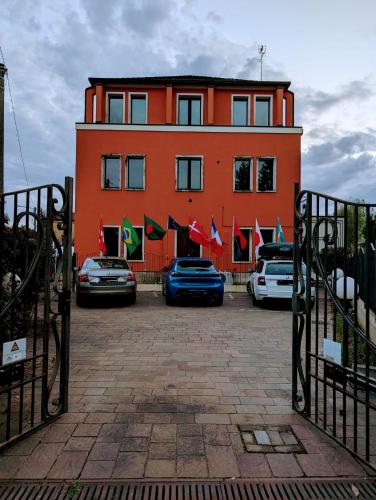 a large orange building with cars parked in front of it at Venice Luxury Apartment in Venice