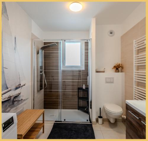 une salle de bain avec douche et toilettes dans l'établissement L'Ecrin du Léman I Thonon-les-Bains, à Thonon-les-Bains