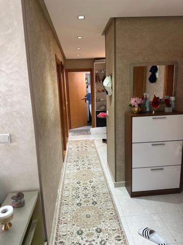 a hallway of a bathroom with a tile floor at Ahmed 205 in Temara