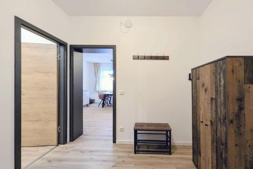 a room with a wooden door and a table at Ferienquartier Forsthaus 2 in Bad Gottleuba