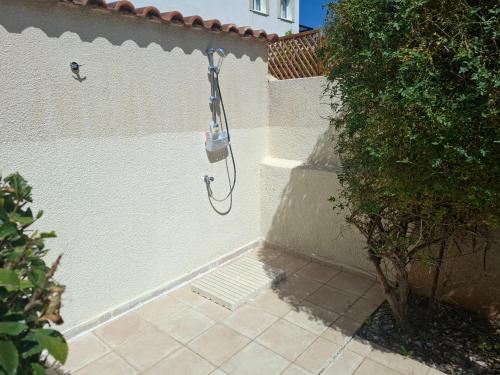a shower in the side of a white wall at Sunset Green 01 in Paphos City
