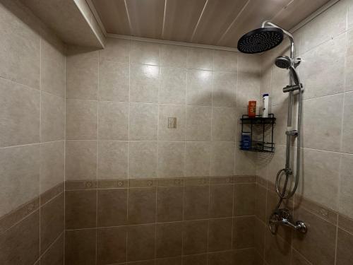 a bathroom with a shower with a shower head at F1 Track view by Bakuapart in Baku