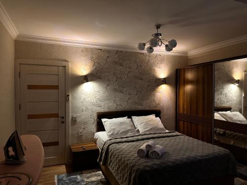 a bedroom with a bed with two towels on it at F1 Track view by Bakuapart in Baku