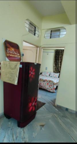 a room with a refrigerator and a bedroom with a bed at Lakeview Flat-Dargah,Pushkar 10mins away in Ajmer