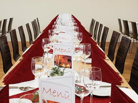 a long table with wine glasses on it at Campus Bad Kissingen in Bad Kissingen