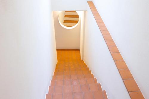 a hallway with a brick floor and a circular window at Lunavi in Forte dei Marmi