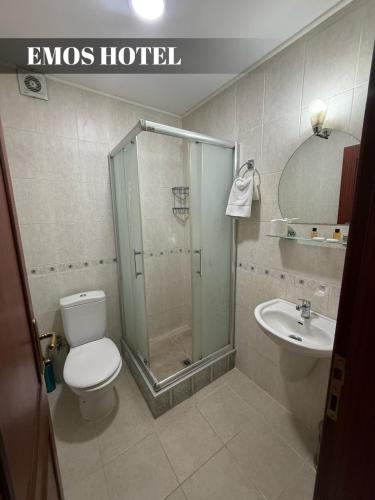 a bathroom with a shower and a toilet and a sink at EMOS HOTEL in Istanbul
