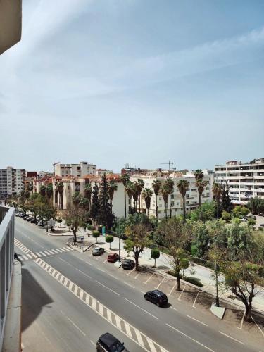 a city street with cars driving down a road at appartement de luxe réservée aux familles in Meknès