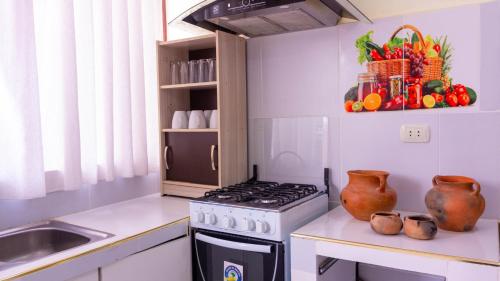 a kitchen with a stove top oven next to a sink at Cabañas SAL Y PIEDRA in Uyuni