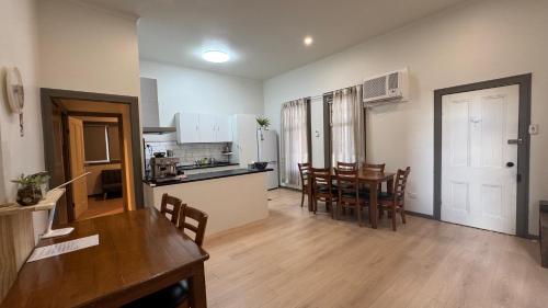 a kitchen and living room with a table and chairs at Diamond House Motor Inn in Stawell