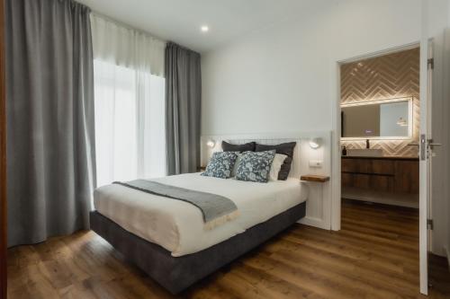 a bedroom with a large bed and a television at São Jorge Holiday Homes in Velas