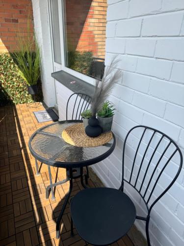 a small table and two chairs on a patio at Rokiskis- jaukus butas su balkonu in Rokiškis