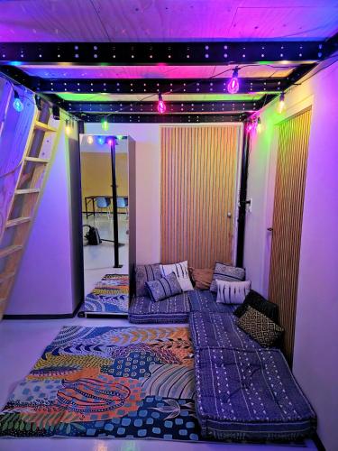 a room with two beds in a room with purple lights at Bij de Salamandras in Stramproy