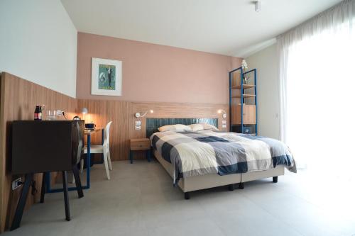 a bedroom with a bed and a table and a desk at Locanda Parsifal in Parma