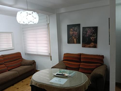 a living room with a couch and a table at Apartamentos San Antón 2 in Córdoba