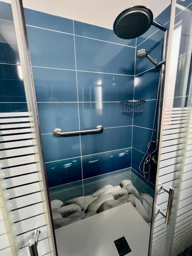 a bathroom with a shower with blue tiles at Buenavista - CHC - Mar Azul in Buenavista del Norte