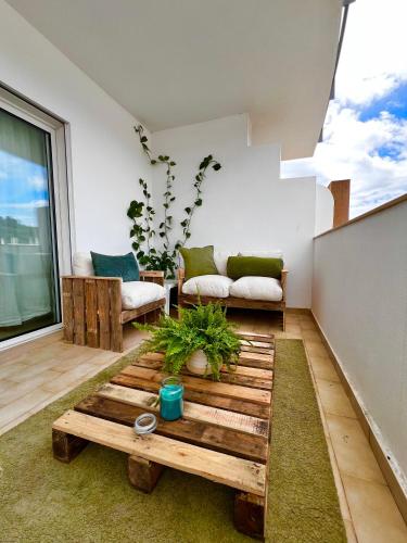 a living room with a couch and a table at Ilumina Hostel Albufeira in Albufeira