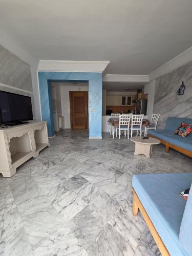 a living room with a couch and a table at Luxurious 2 bedroom apartment in Sousse