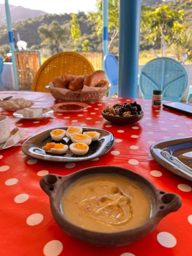 a table with a bowl of soup and food on it at Dar Zitouna in Chefchaouene