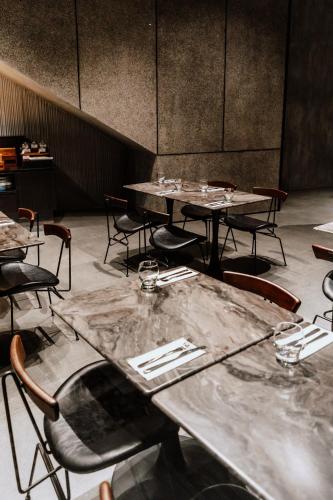 an empty dining room with tables and chairs at The Funny Lion - El Nido in El Nido
