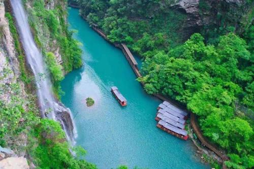 an aerial view of a river with two boats in it at Tongfu Inn(In the National Park) in Zhangjiajie