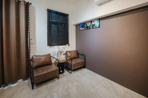 a waiting room with two chairs and a window at Shishi Homestay in Wujie