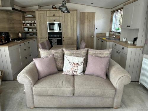 a couch with two pillows on it in a kitchen at Lodge 2 The Wee Hut Aviemore in Aviemore