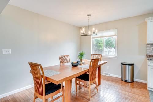 a dining room with a wooden table and chairs at 3 Mi to Dtwn Saginaw Spacious and Updated Home! in Saginaw