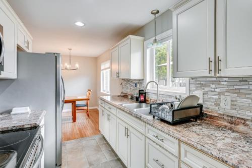 a kitchen with white cabinets and a sink at 3 Mi to Dtwn Saginaw Spacious and Updated Home! in Saginaw